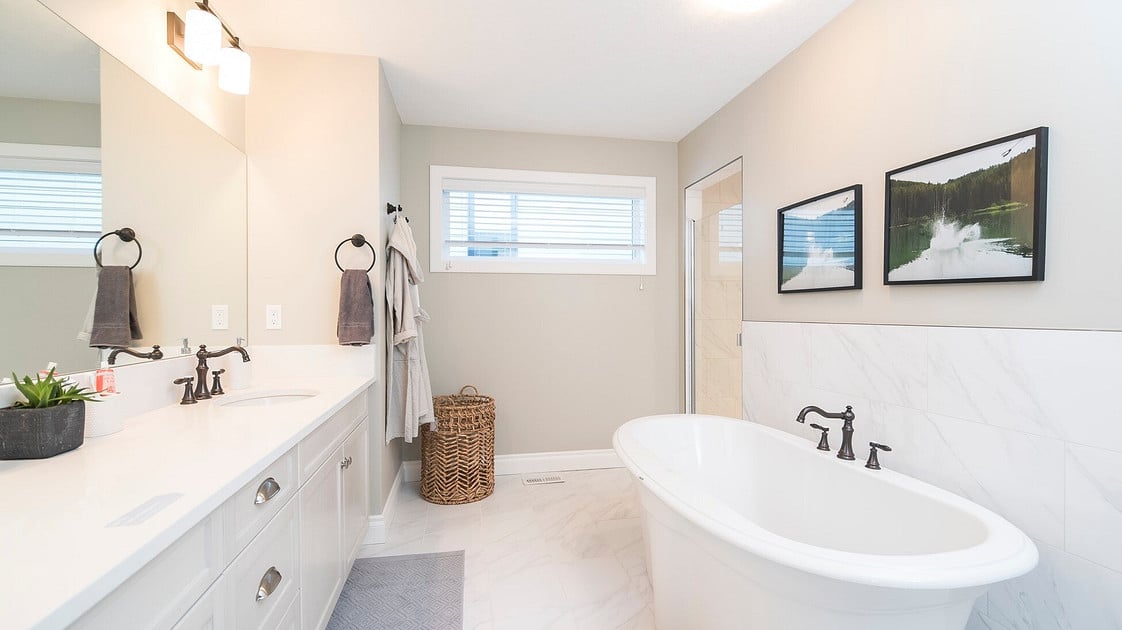 White tub in a light beige bathroom